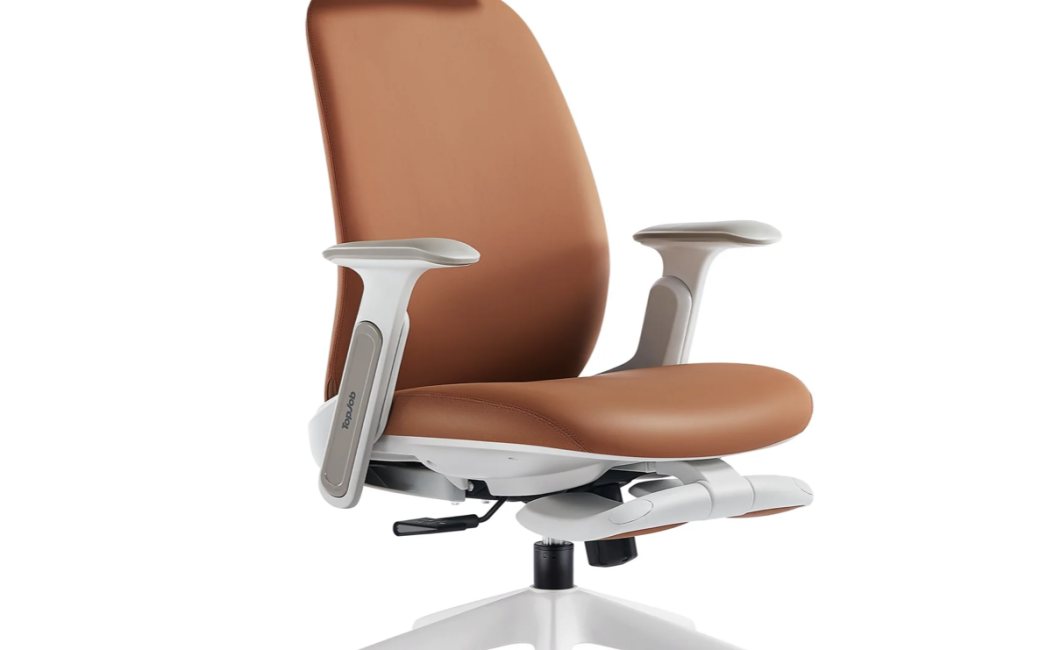 Oblique view of the TopJob Napa ergonomic chair. The fabric on the seat, back, and headrest is vegan leather while the frame, armrest, and footrest supports are white. The retractable footrests are folded under the seat in their stowaway position. Black seat height and tilt adjusters are visible under the seat. The chair is supported by five radial legs that each end in a black wheel.